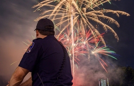 police officer watching fireworks