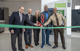 Image of Howard County Executive Calvin Ball and fellow local and state officials cutting a ribbon to mark the arrival of the Farmer's Fridge healthy vending machine to the Circuit Courthouse in Ellicott City.