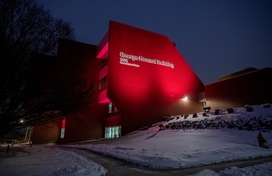 Image of the County's George Howard Building lit in burgundy color lighting in support of the Washington Commanders as they head into the 2024 season NFC Championship game in their bid for Super Bowl LIX.