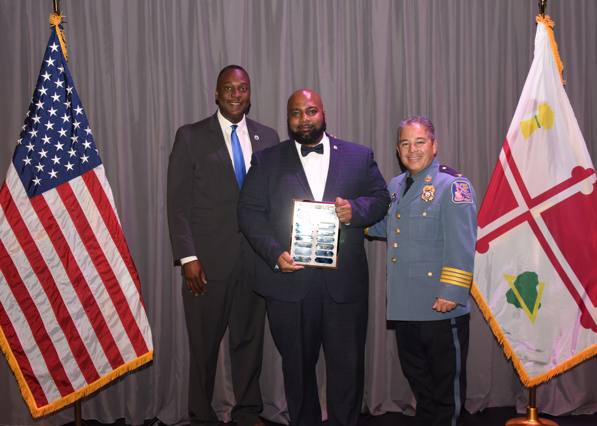 CAC member Andrew Hall, County Executive Ball and Chief Der posing at the HCPD annual award ceremony. 