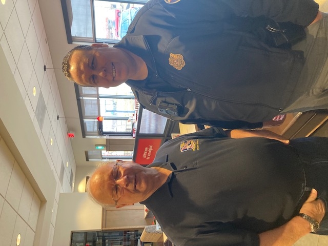Citizen Advisory Council member poses with an HCPD officer during an Coffee with a Cop event.