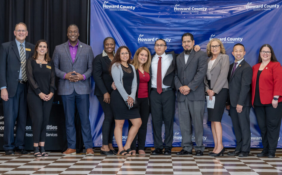 Alex Morales, winner of the Commission on Disabilities' 2023 Achievement Award (Youth), surrounded by Commission members and Howard County Executive Calvin Ball and other elected officials. 