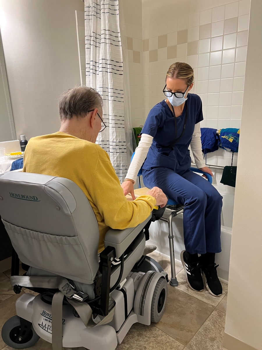 OT demonstrating tub transfer to a person on a wheelchair