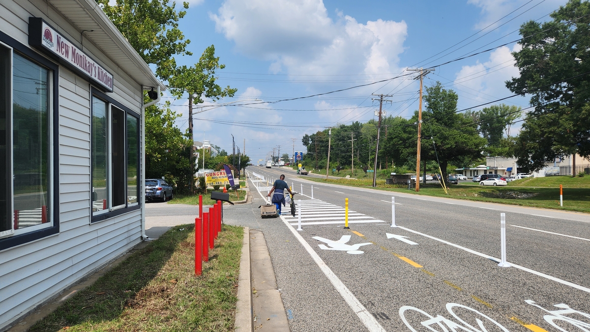 Complete Streets Leadership Academies - US 1 Quick-Build Demonstration Project Man Walking with Bike