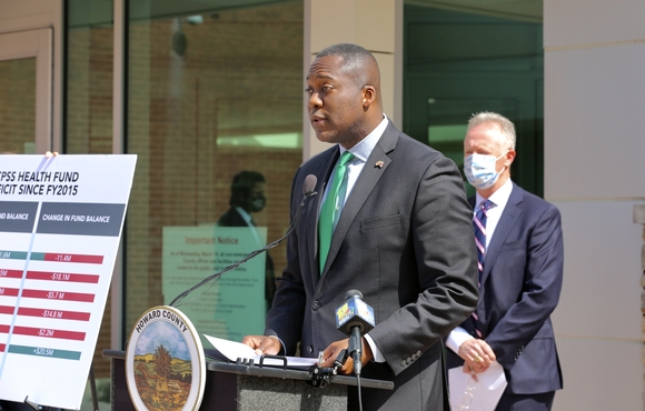 Calvin Ball standing at podium in front of building