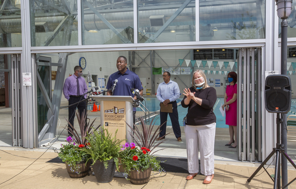 Calvin Ball at podium in front of Roger Carter Center pool