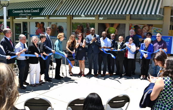 Image of local leaders cutting a blue ribbon on the head start center in long reach village center