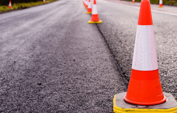 Paved road with orange traffic cones