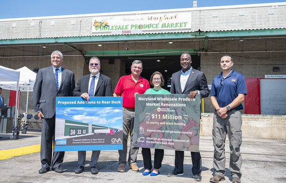 Group of officials standing in front of the Wholesale Produce Market in Jessup