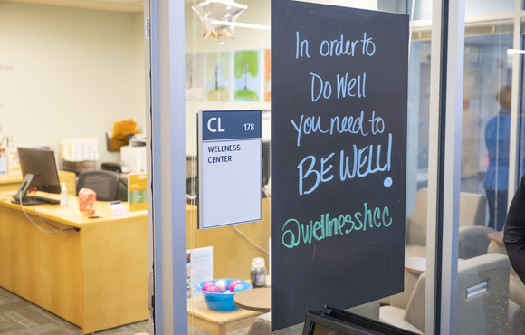 HCC wellness center. Signs reads "in order to do well you need to be well."