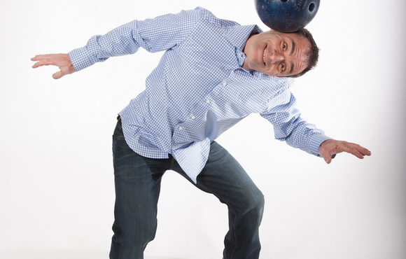 Circus performer Michael Rosman balancing a bowling ball on his head