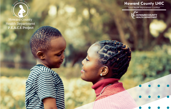 Black woman smiling at young black boy outdoors.