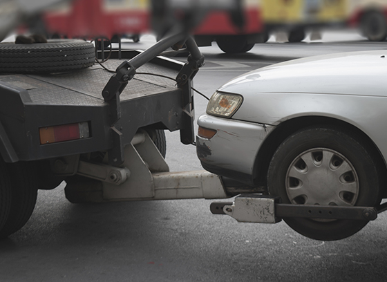 Photo of a tow truck towing a car.