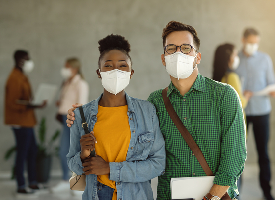 African American female and white male wearing medical masks