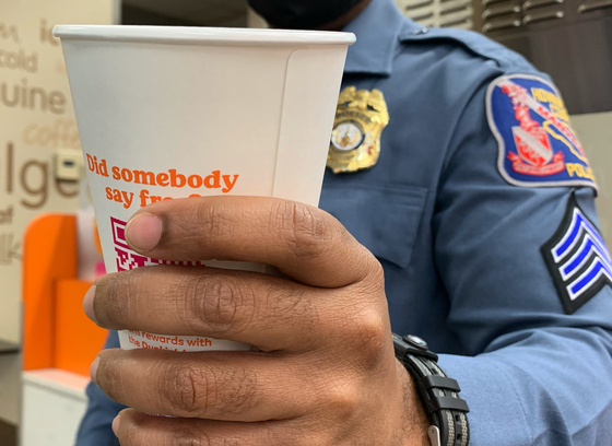 Officer holding a cup