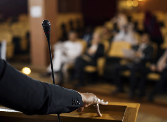 A woman giving a speech from a podium 