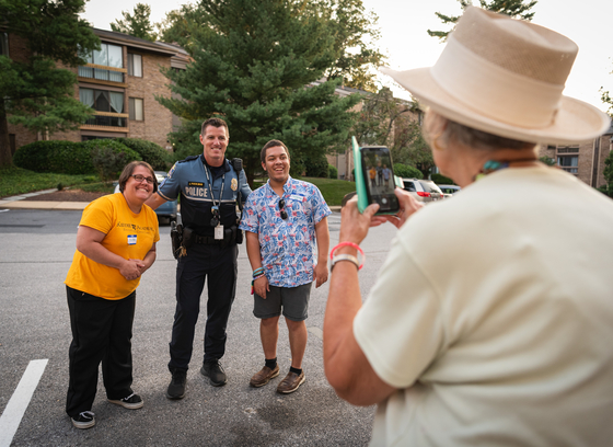 Officer poses with a group of citizens during national night out