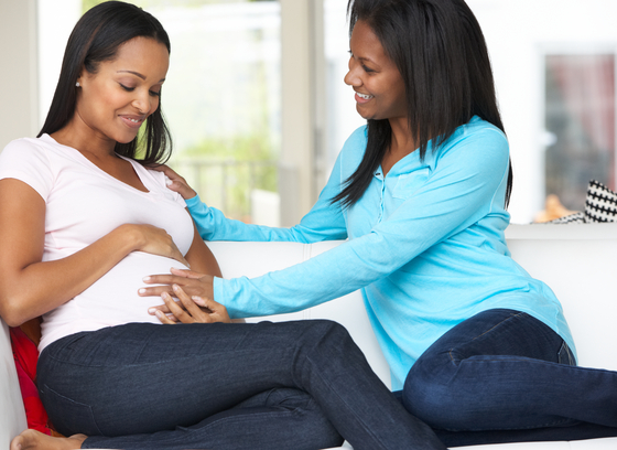 Pregnant African American female with friend
