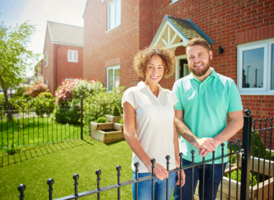 Home owners in front of their home