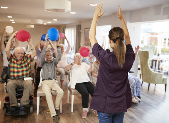 Carer Leading Group older adults in social day program 