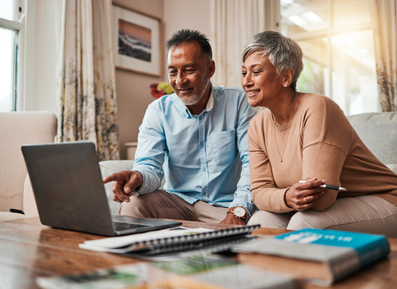 Older adult couple looking at their computer planning for their future