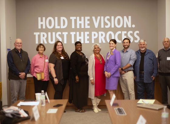 The Commission on Aging in a board room smiling