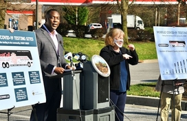 Calvin Ball at podium with mobile testing posters