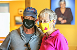 man and woman wearing masks