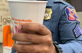 Officer holding a cup