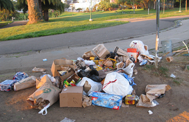 Trash and litter piled up next to a road
