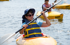 woman in a kayak with other kayaks in the background