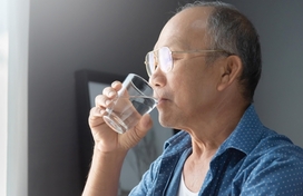 asian senior man drinking water