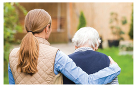 A woman comforting an older adult woman. 