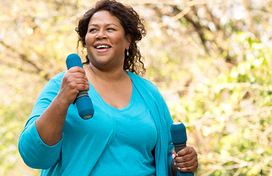 Lady holding weights whilst walking 