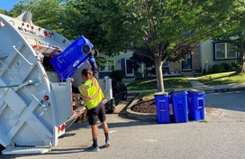 contractors emptying recycling carts