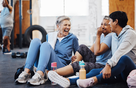 Group of people laughing in a gym class