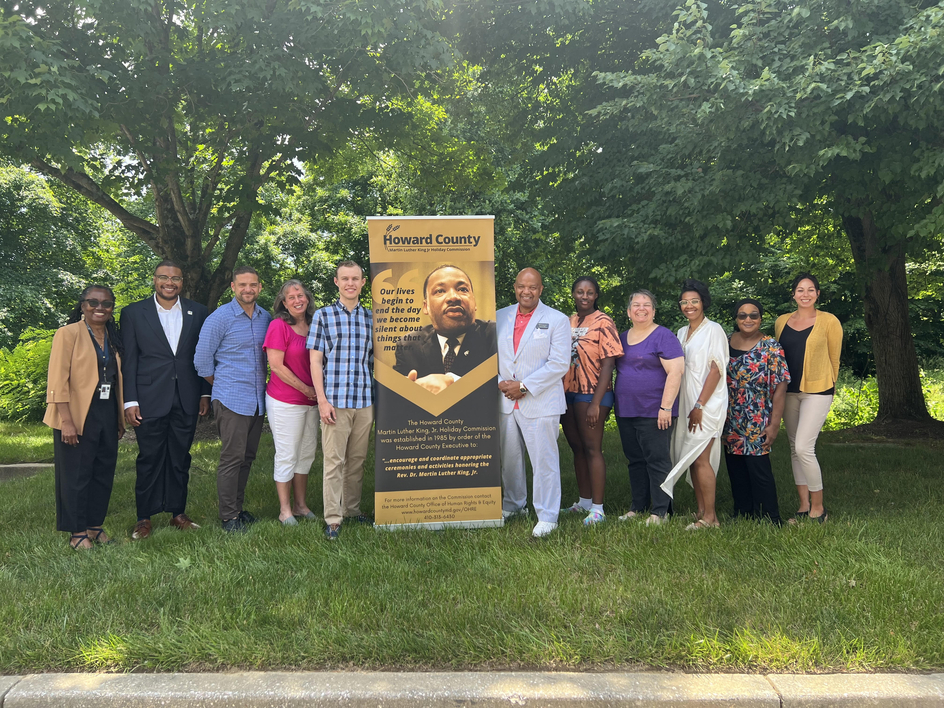 MLK Commissioners posed with commission Banner 