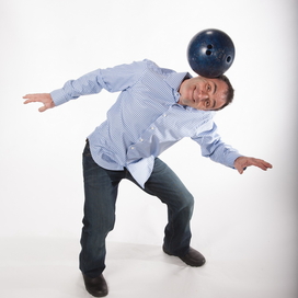 Circus performer Michael Rosman balancing a bowling ball on his head