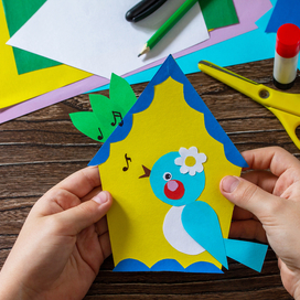 creating a birdhouse craft with construction paper